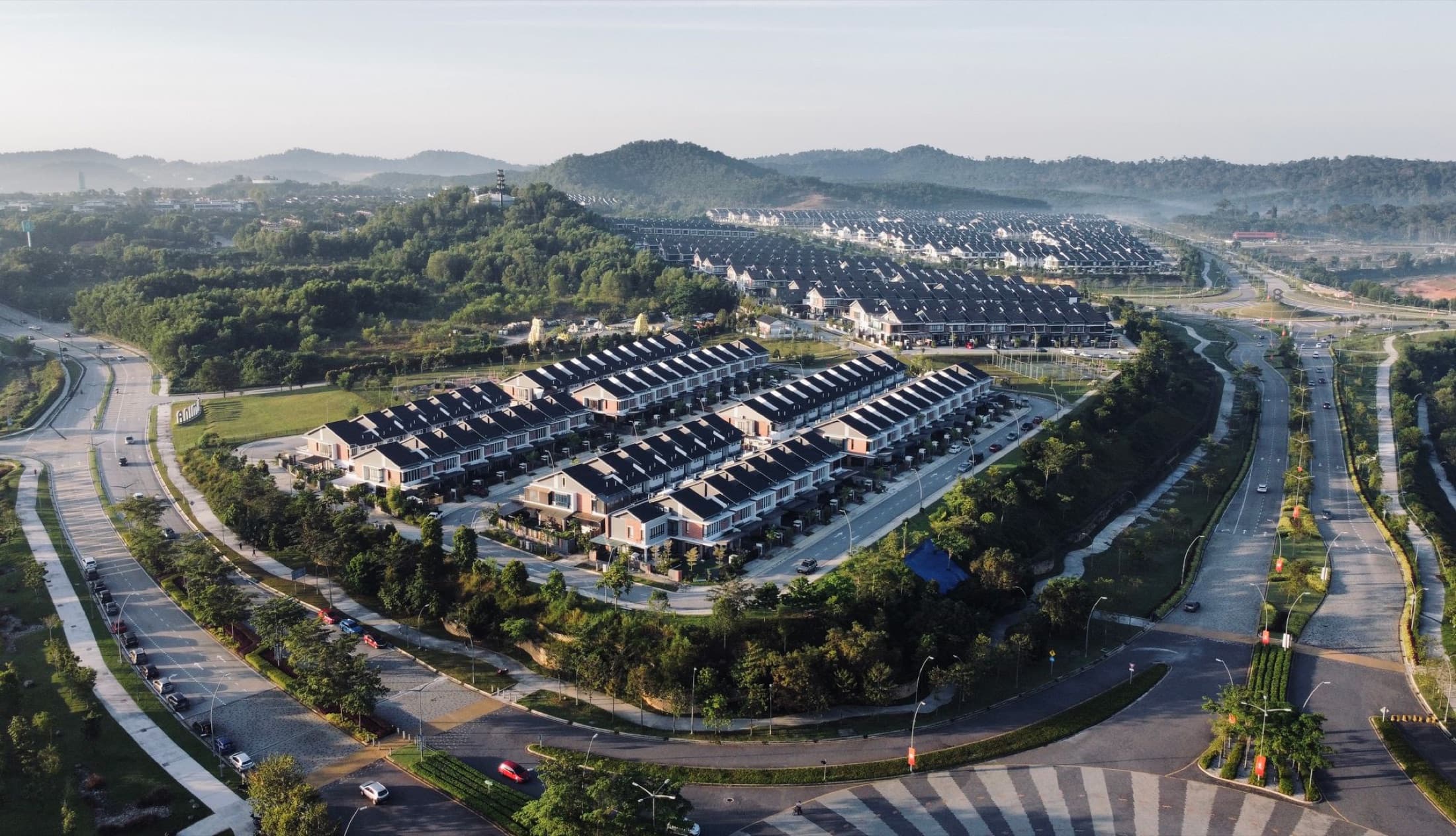 Aerial view of a modern master-planned community with roads, landscaping and phased housing